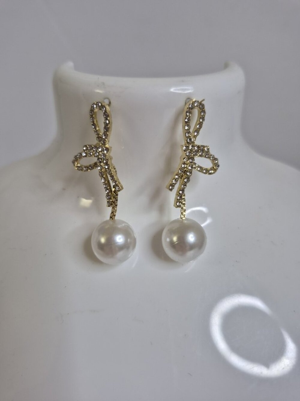 Rhinestone-Studded Gold Bow Drops With A Hanging Faux Pearl Earrings